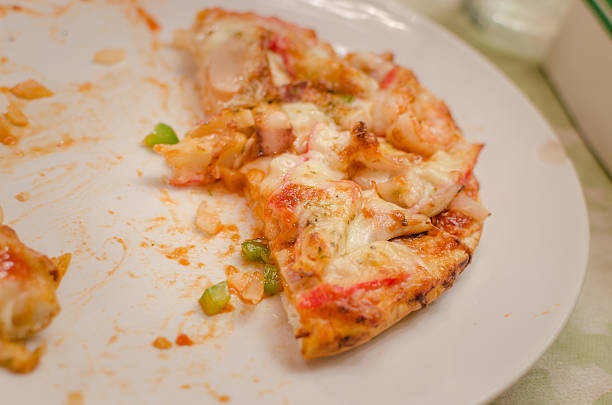 istock piece of pizza remains on plate 502273813
