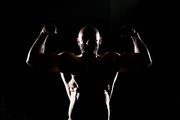 istock Siluet Muscular Man Flexing Muscles 502274957