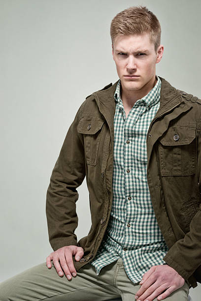 istock Man sitting in front of green background 502276343