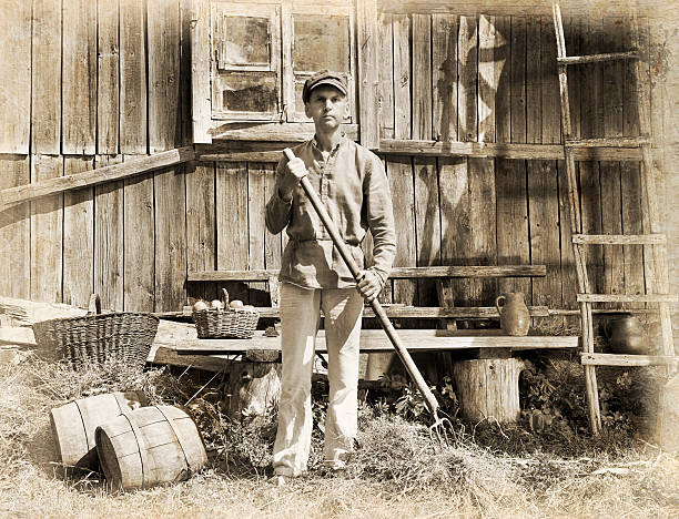 Man with a pitchfork Male farmer holding a pitchfork. Intentional 1900's style post processing emulation.. antique pitchfork stock pictures, royalty-free photos & images