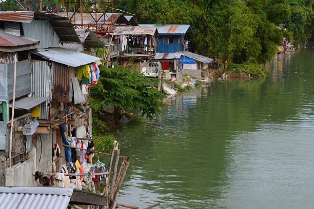 Impoverished houses situated on the river bank. Stilt houses on Davao river, Poblacion district - Davao city davao city stock pictures, royalty-free photos & images