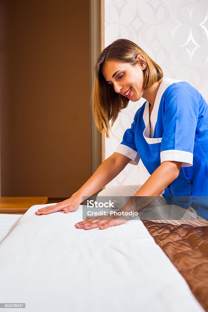 Maid making bed Photo of maid making bed in hotel room 30-39 Years Stock Photo