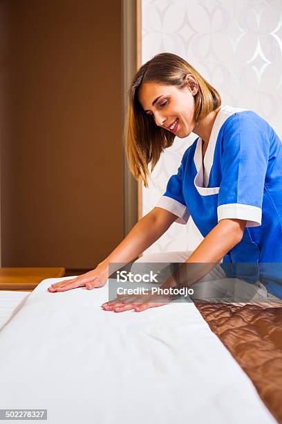 Maid Making Bed Stock Photo - Download Image Now - 30-39 Years, Adult, Adults Only