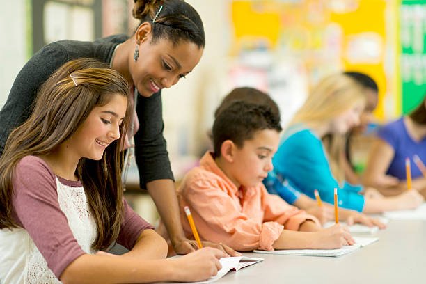 Elementary classroom Elementary school students in their classroom. junior high stock pictures, royalty-free photos & images