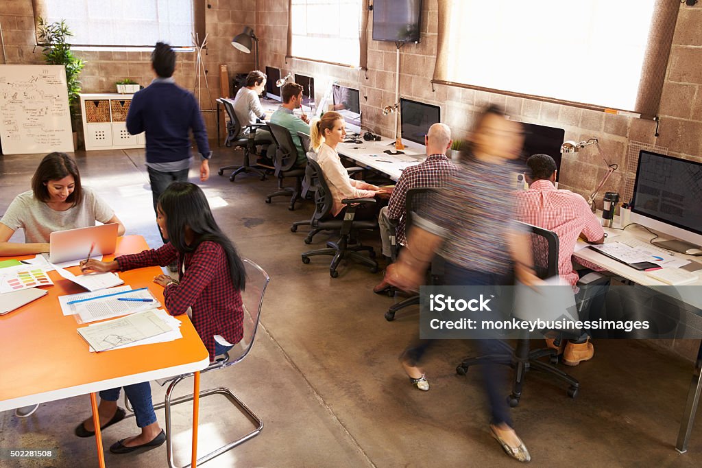 Elevated View Of Workers In Busy Modern Design Office Office Stock Photo