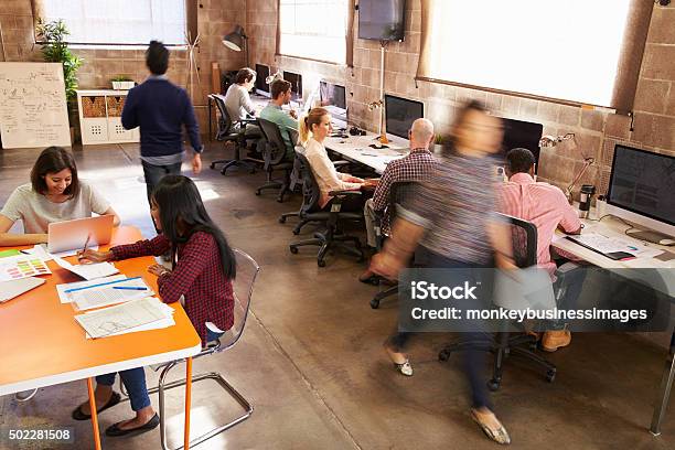 Elevated View Of Workers In Busy Modern Design Office Stock Photo - Download Image Now