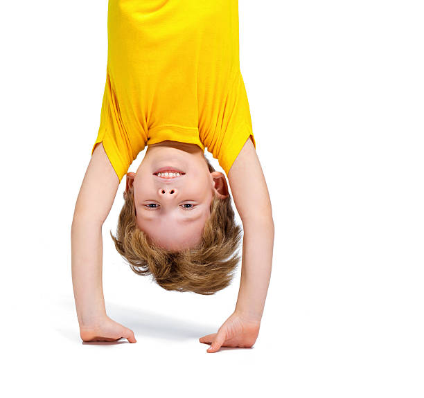 istock Handsome little boy hanging upside down 502281512