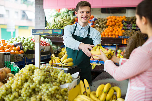 istock seller weighing bananas 502281718