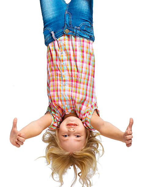 istock Beautiful little girl hanging upside down 502282514
