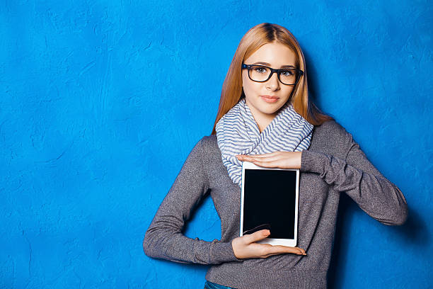 istock Cute girl against blue wall 502284118