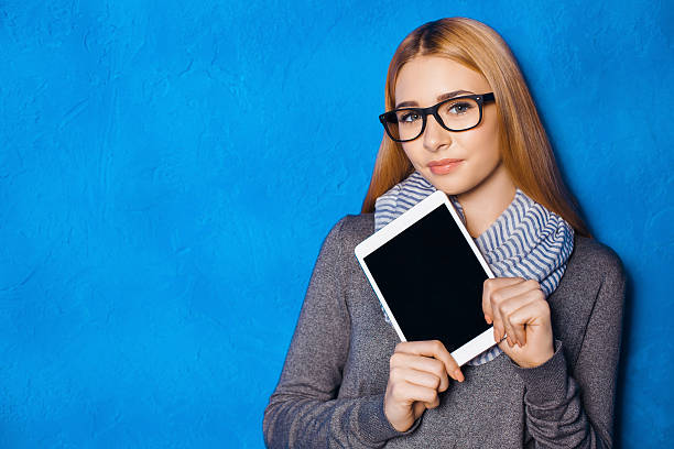 istock Cute girl against blue wall 502284142