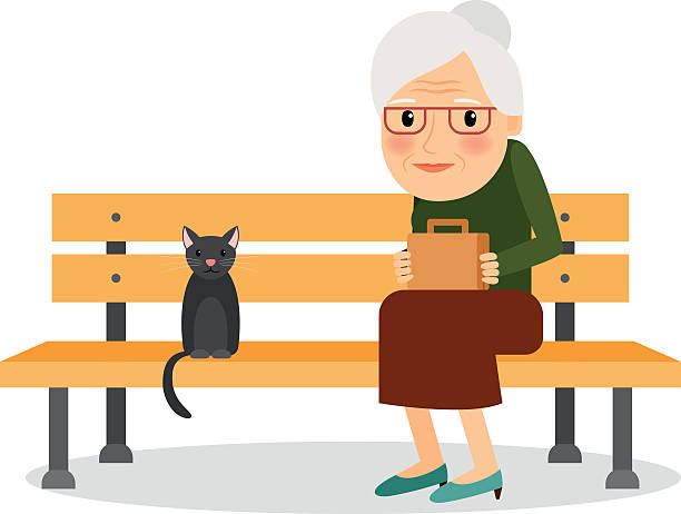 istock Elderly woman and cat sitting on park bench 502284832