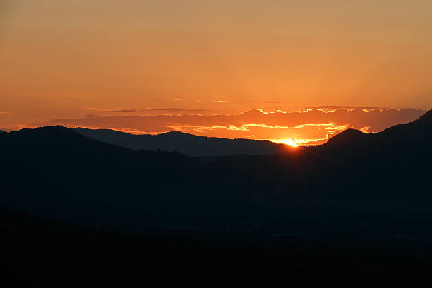 istock Sunset landscape orange sky and silhouette mountian 502285738