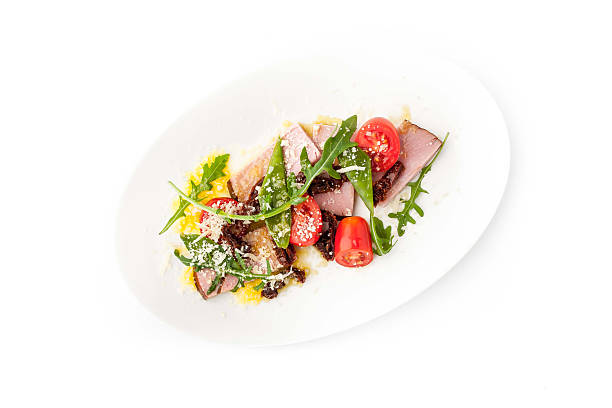istock Salad with smoked ham and arugula in white background horizontal 502285774