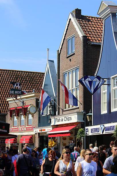Volendam, Netherlands - August 20, 2015: Tourists stroll along the main street of Haven in the traditional Dutch town of Volendam. The town is located on the Ijsselmeer and has a seaside resort atmosphere.