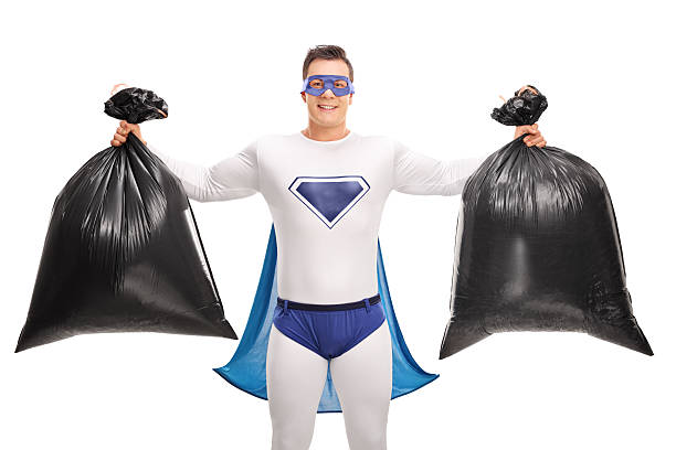 super-herói segurando dois sacos de lixo - recycling green environment superhero - fotografias e filmes do acervo