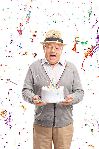istock Overjoyed senior holding a birthday cake 502287350