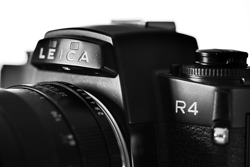 Antibes, France - December 20, 2015: Detail shot of the Leica R4 single-lens reflex (SLR) film camera. Several Leica R4 models were produced by by the Leitz company between between 1980 and 1987. The R-System, produced in cooperation with Minolta Corporation during iterations R4 until R7, was discontinued in 2009.