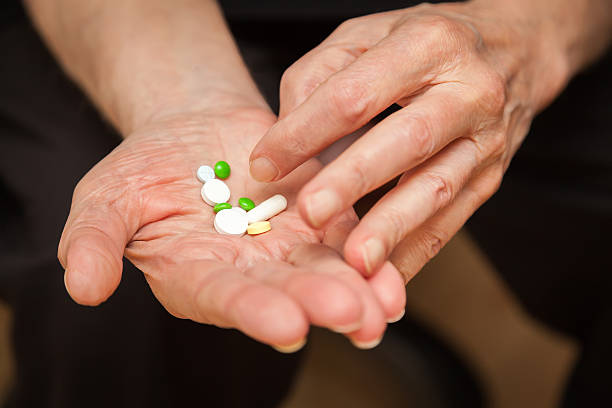 istock close-up old man's hands with pills 502288450