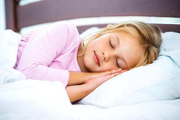 istock Little girl sleeping on white bed 502289266