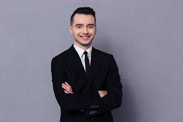 istock Smiling businessman standing with arms folded 502289586