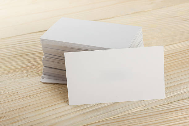 istock White blank business visit card, ticket, pass, present  wooden background 502289714