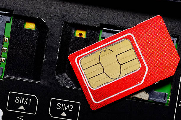 istock Red SIM card on slots in mobile phone. 502291402