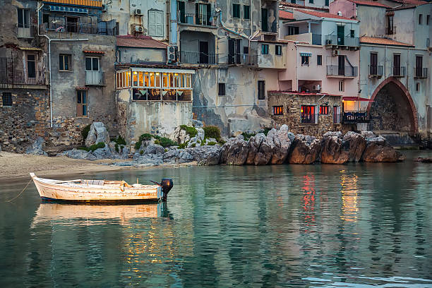 old small boat in the harbor of Cefalu old small boat in the harbor of Cefalu at dusk, Sicily cefalu stock pictures, royalty-free photos & images