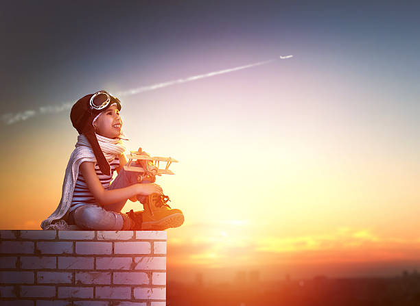 istock girl playing with toy airplane 502295358