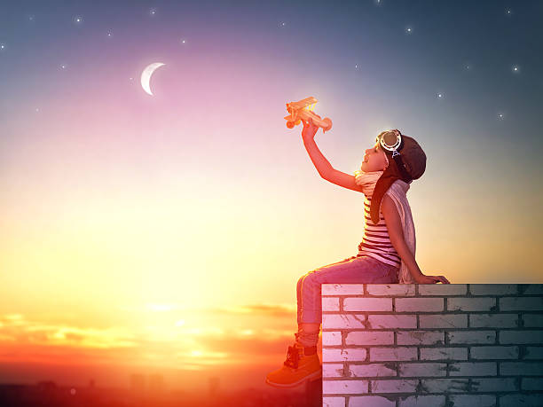 istock girl playing with toy airplane 502295430