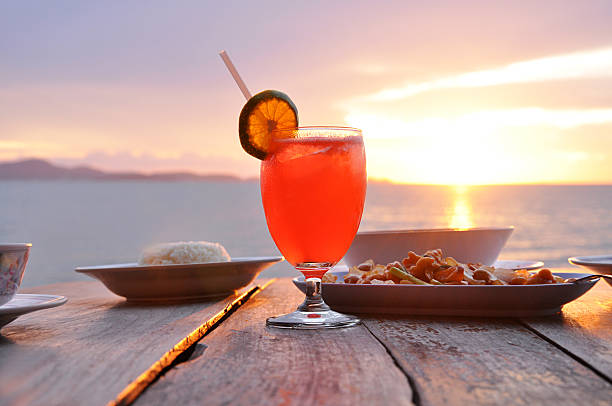 istock Cocktail drink with orange slice garnish on old wooden table 502296745