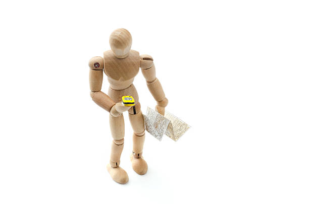 istock wooden mannequin hiking with GPS and map 502297240