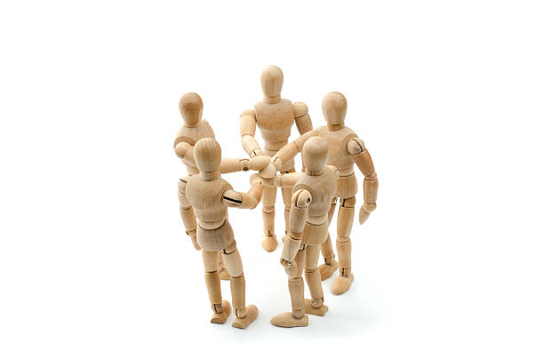 istock all for one - Wooden mannequin putting hands together 502297384