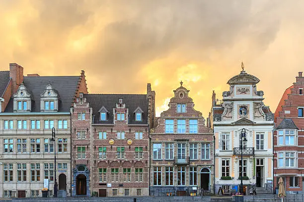 Beautiful sunset old buildings on Korenlei embankment in Ghent, Belgium