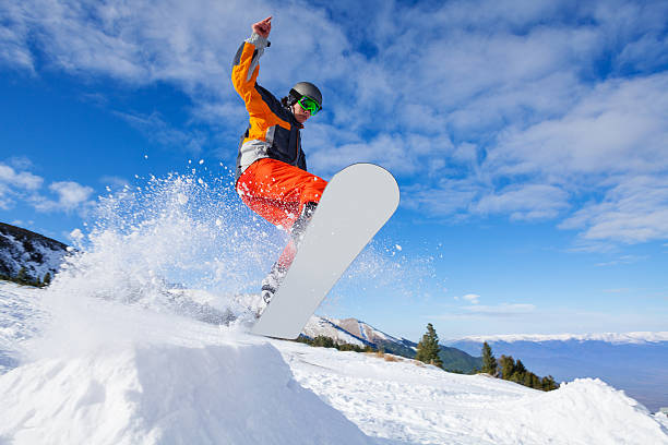 istock Jumping snowboarder from hill in winter 502297655