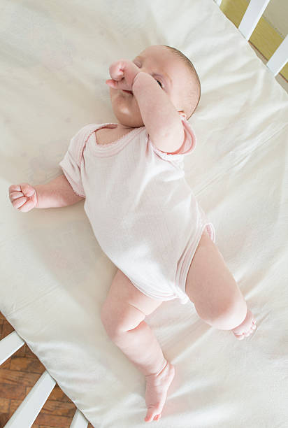 istock Baby in a baby bed 502298402