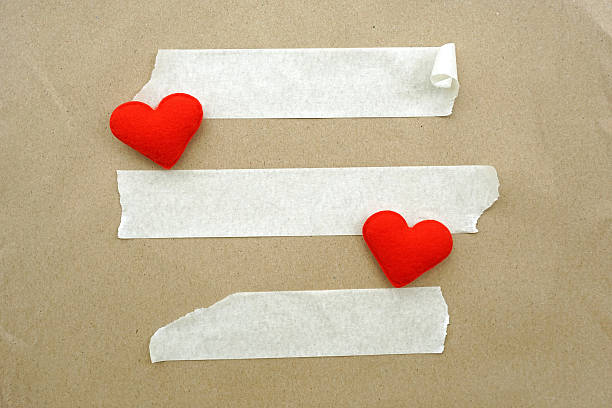 istock Brown paper, white tape and heart shape for background 502299749