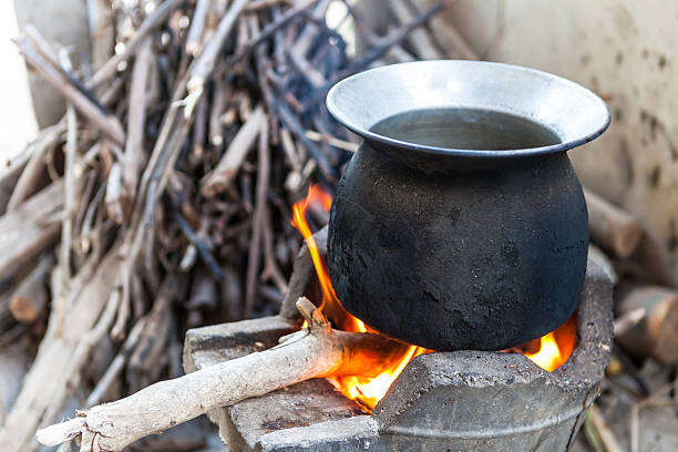 istock black pot boiling water for cooking, fired stove, firewood 502299837