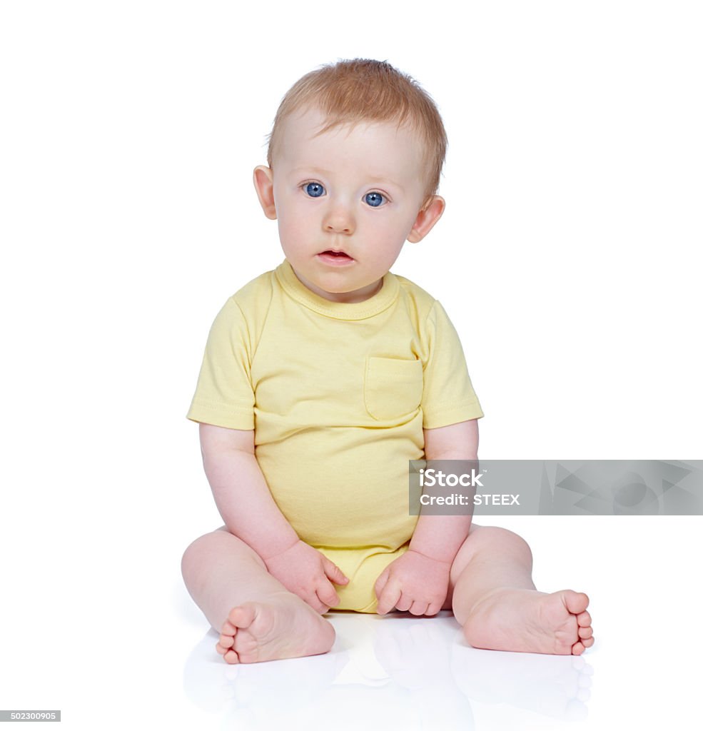 Calm and peaceful Studio shot of a cute baby boy sitting on the floor 6-11 Months Stock Photo