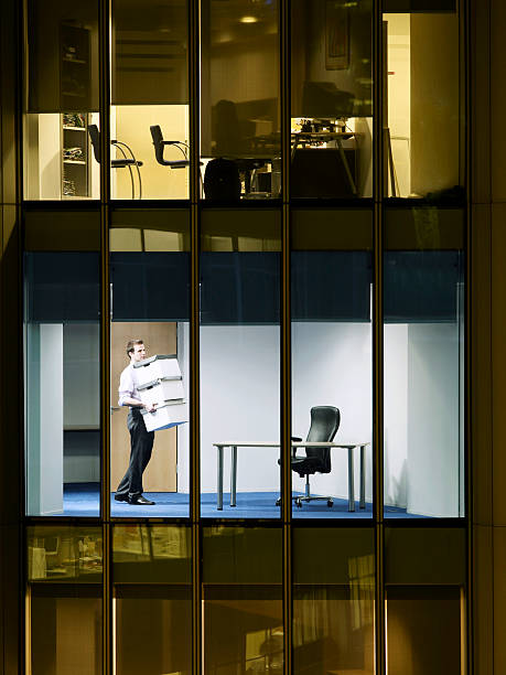 istock Businessman Carrying Stack Of Boxes In Office 502301211