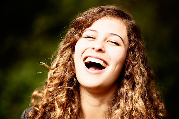 istock Cute, curly-haired young beauty roars with laughter 502301481