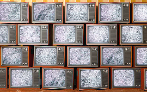 istock Stack of vintage old televisions showing static signal, piled up 502301697