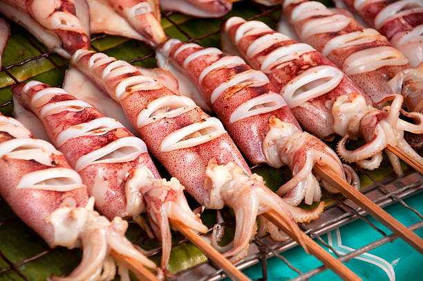 Special Grilled fresh squids in open market of Thailand Special Grilled fresh squids in open market of Thailand loligo stock pictures, royalty-free photos & images
