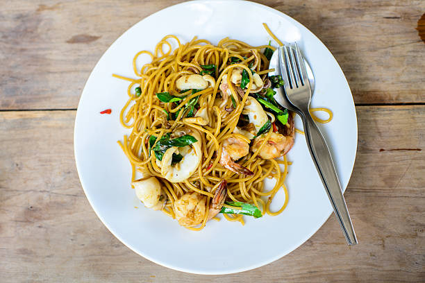 istock Spicy paghetti with seafood on wooden table. 502303633