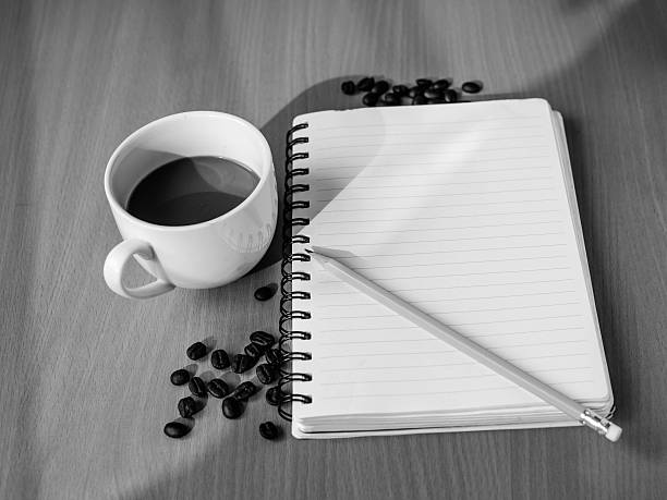 glasses, pencil, notebook, white mug on the wooden table outdoor and copy.