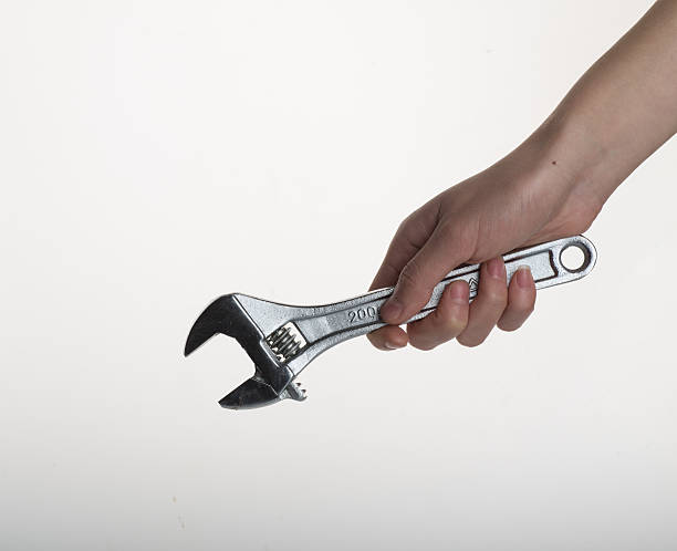 istock Hand of worker with a wrench closeup 502312450