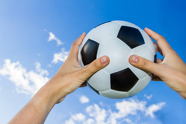 istock holds a soccer ball in the sky on blue sky 502313068