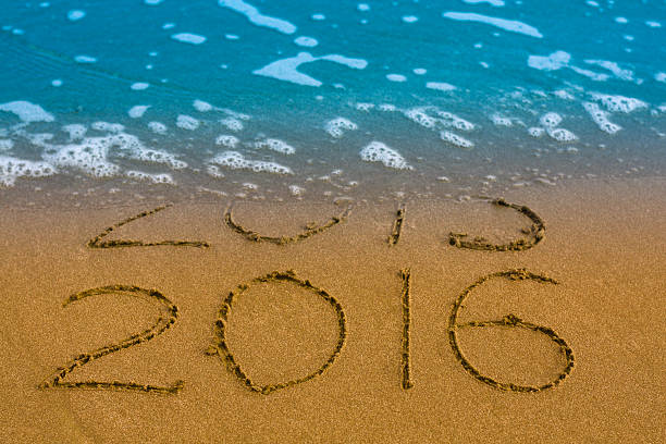 istock Happy New Year 2016 replace 2015 concept on sea beach 502314624