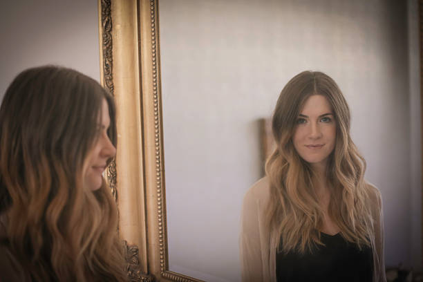 istock Woman with mirror behind her 502315612