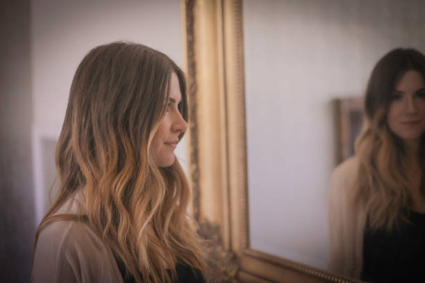istock Woman with mirror behind her 502315652